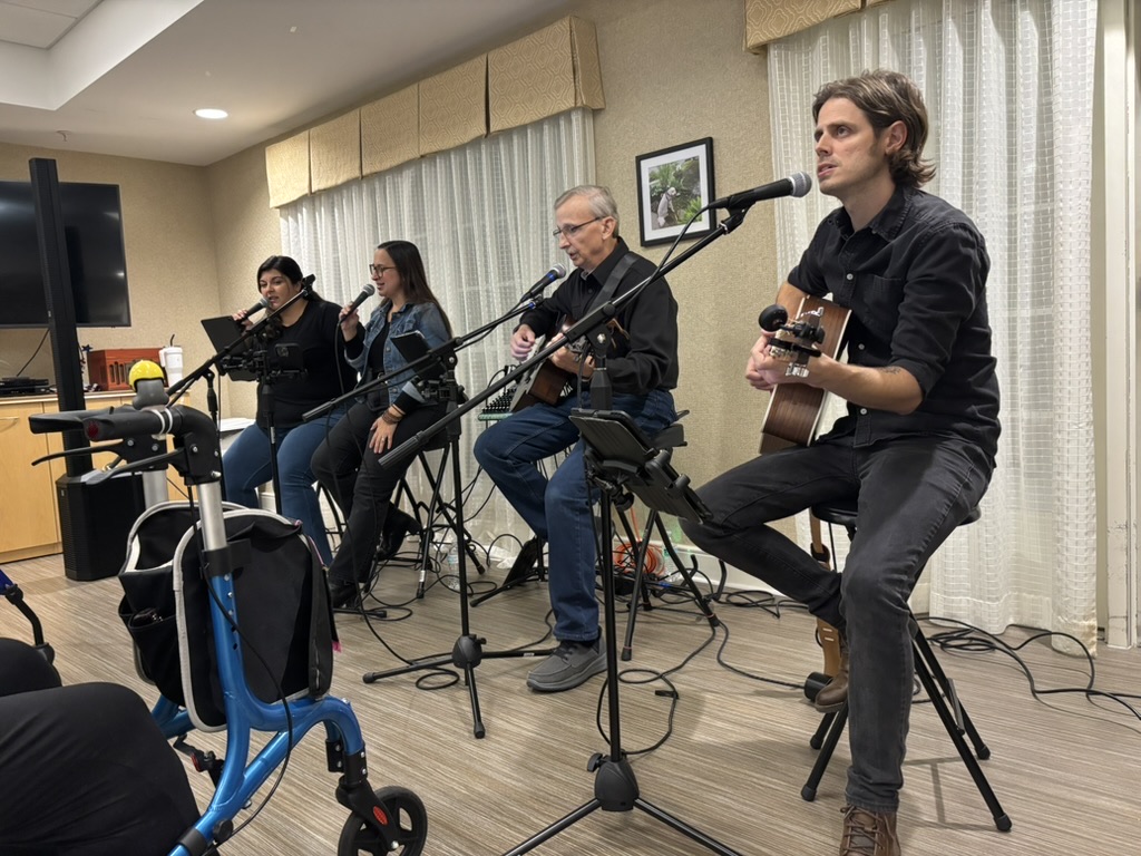 Four team members performing at a nursing home