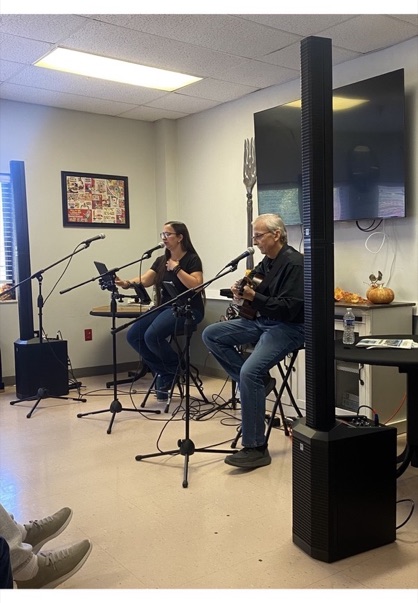Jess and Keith seated and performing side by side